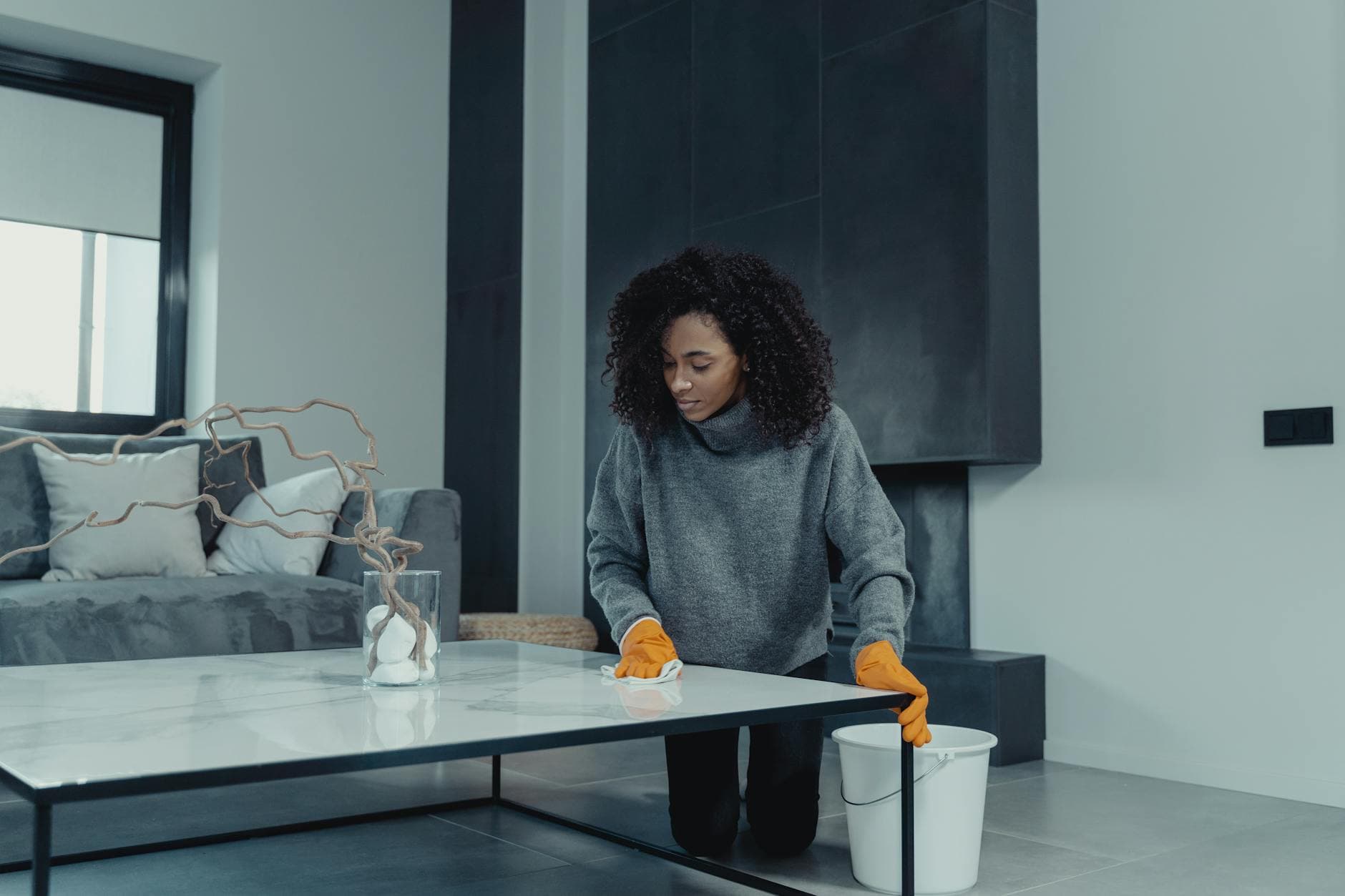 Professional house cleaner wiping a table in a contemporary apartment — Bi-Weekly Cleaning in New Jersey
