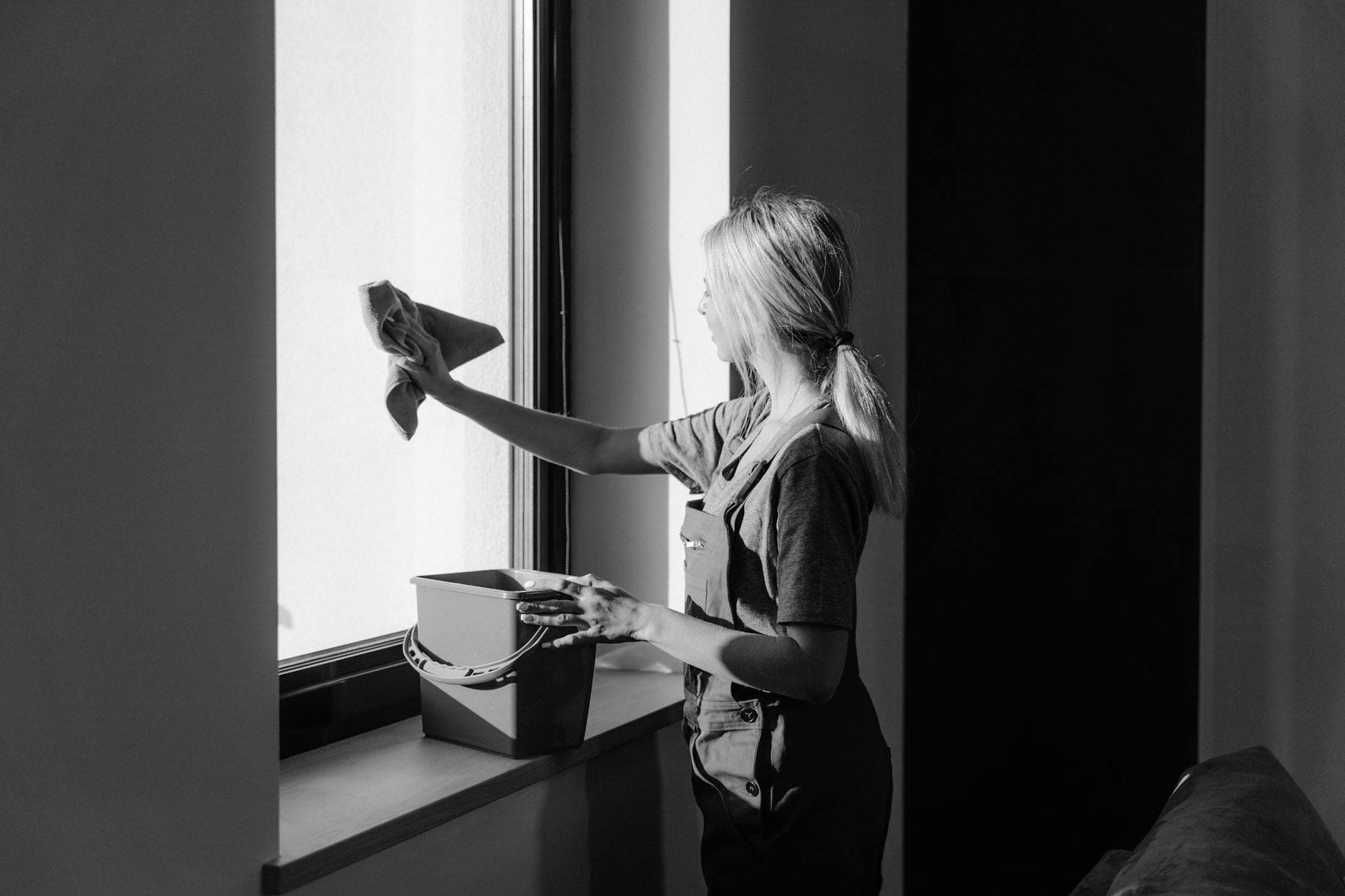 Professional window cleaning in a New Jersey apartment using cloth and bucket — cleaning services in North Brunswick, Central Jersey